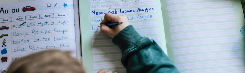 child learning to write. Developing their fine motor skills