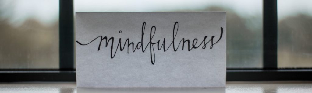 picture of a piece of paper in a window with the word 'mindfulness' written on it. Adult Occupational Therapy Services