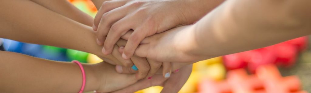 group of hands overlapping on top of each other