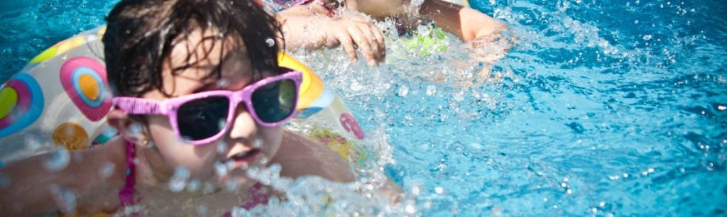 picture of toddlers playing in a swimming pool. SPD, sensory play, water play, sand play, messy play.