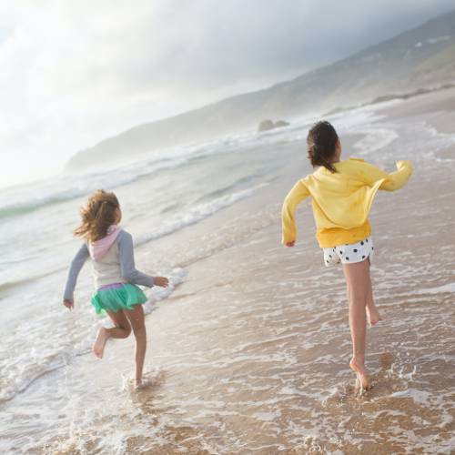 two-girls-running-on-a-beach Sensory Processing Challenges: Assessment and Treatments