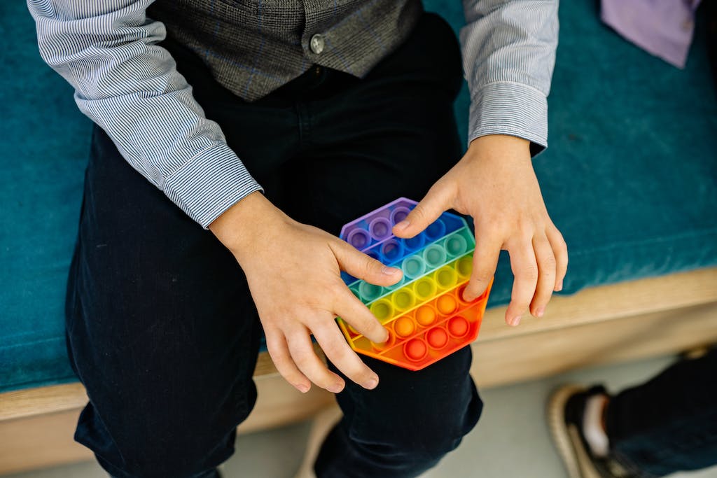 Close Up Shot of a Person Playing Pop It Toy