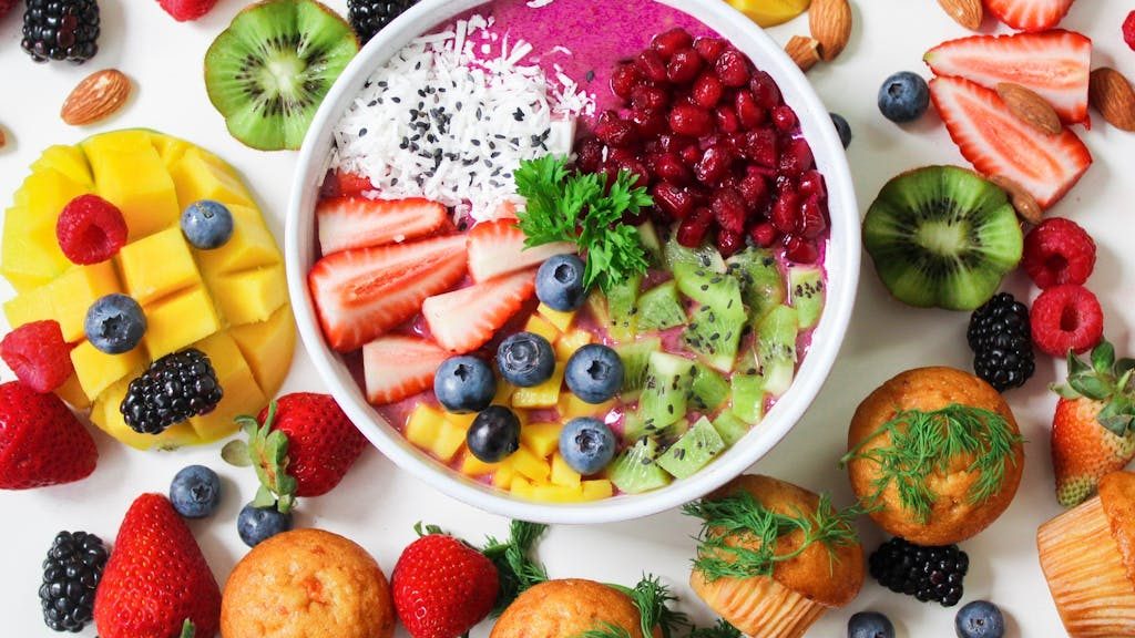 Assorted Sliced Fruits in White Ceramic Bowl