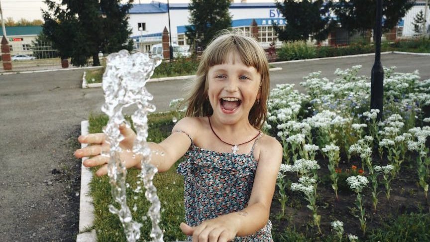 Girl Playing with Water. sensory water play.