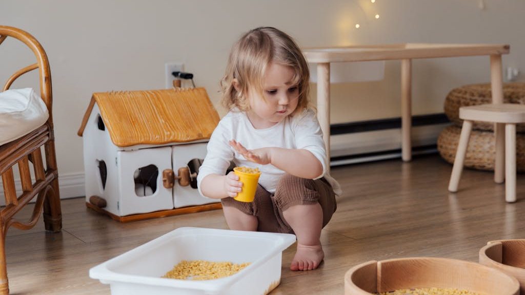 Girl Holding Yellow Plastic Cup Full of Macaroni