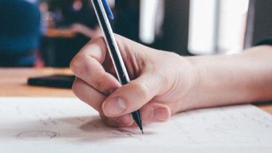 Photo of someone writing. handwriting assessments and treatment