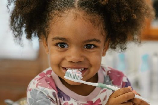a little girl brushing her teeth